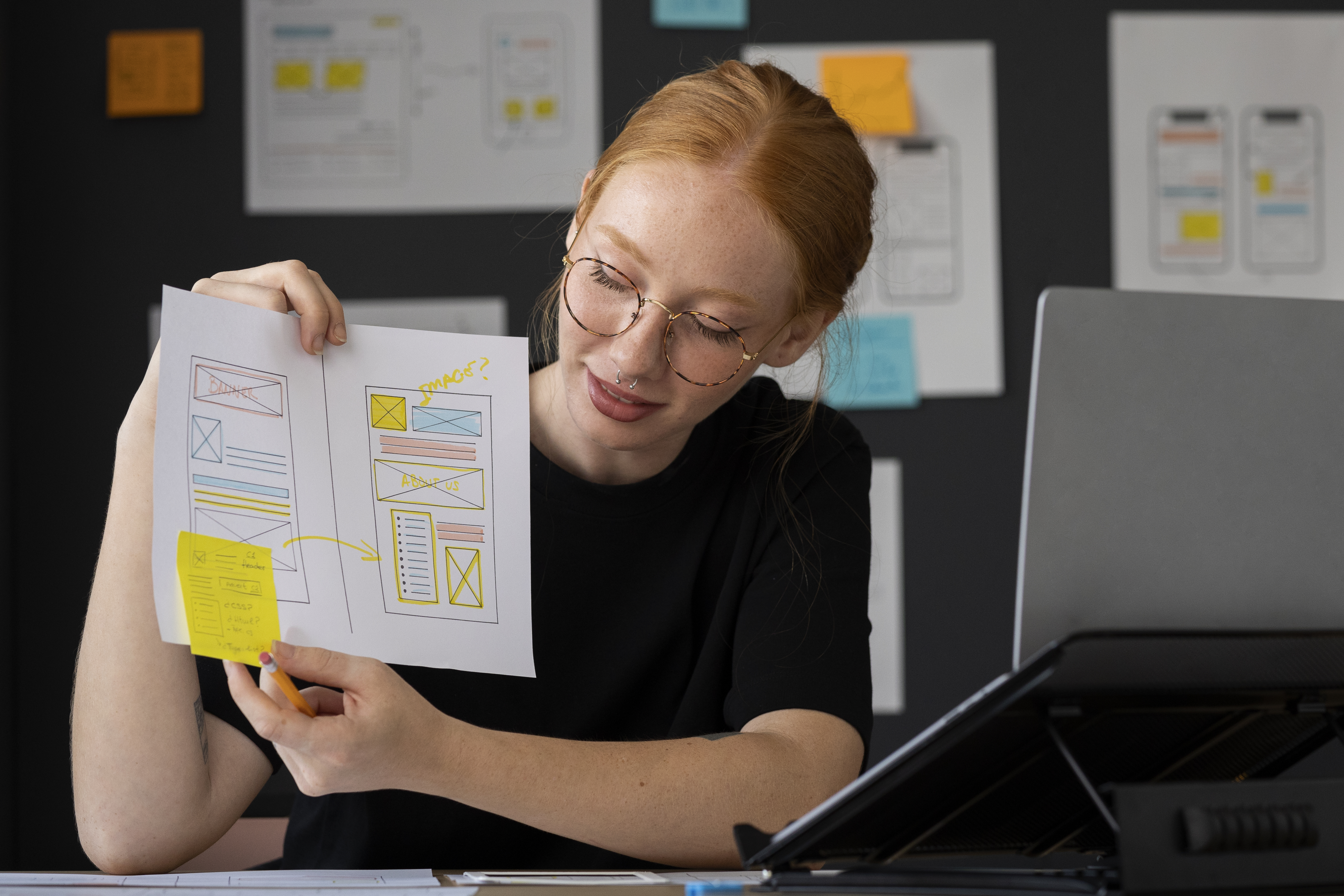 female-web-designer-with-papers-notes-office.jpg